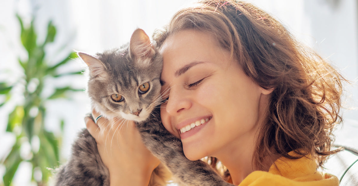 Woman with allergies holds a cat